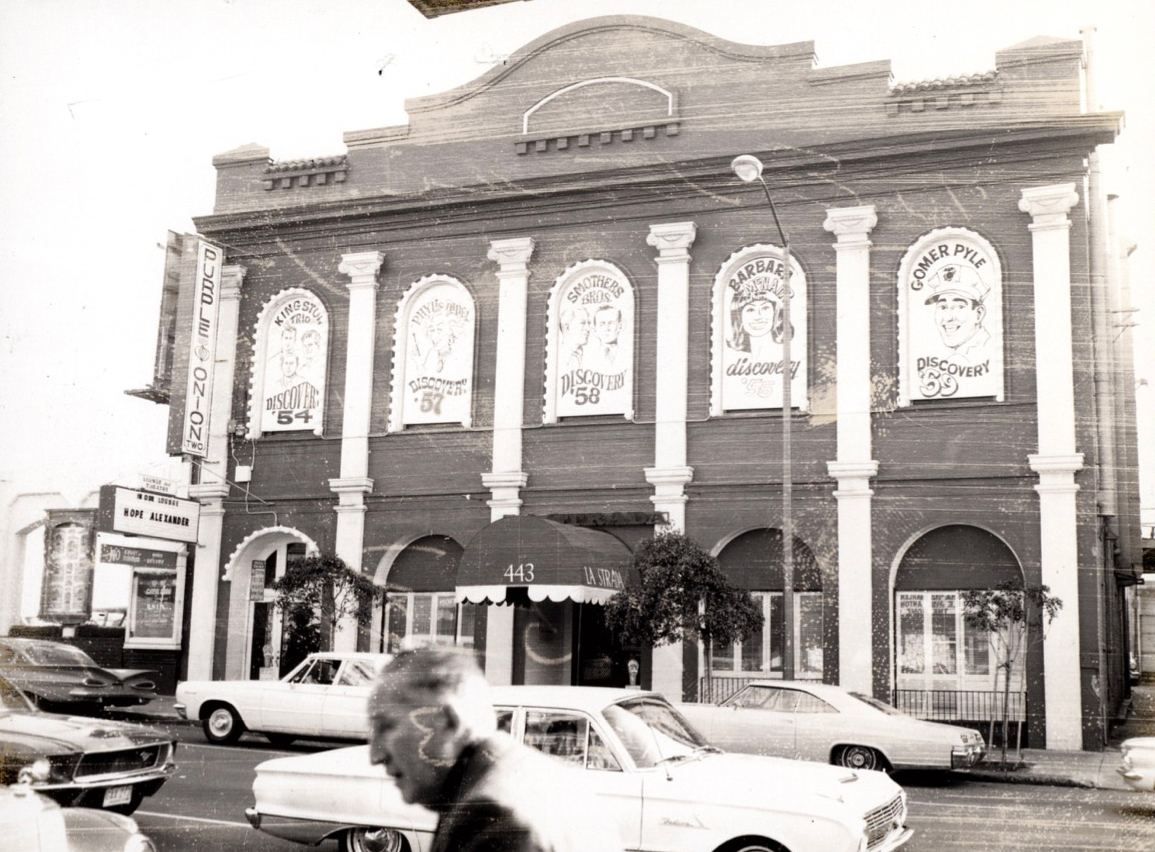 The 435 Broadway facade with Purple Onion sign and Discovery caricature windows