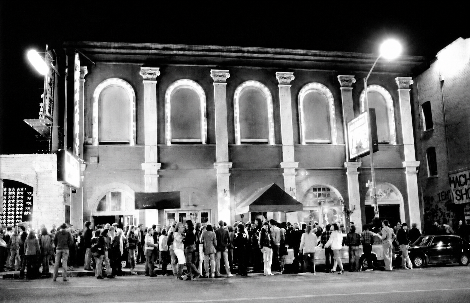 A crowd outside the lit facade at night during the Mabuhay Gardens punk era